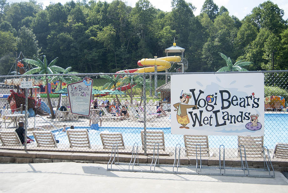 yogi bear's wet lands photo showing chairs with pool and water slides - Campground Info