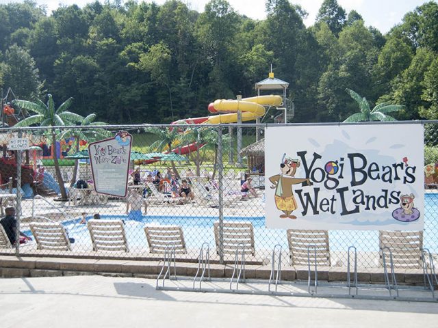 yogi bear's wet lands photo showing chairs with pool and water slides - Campground Info