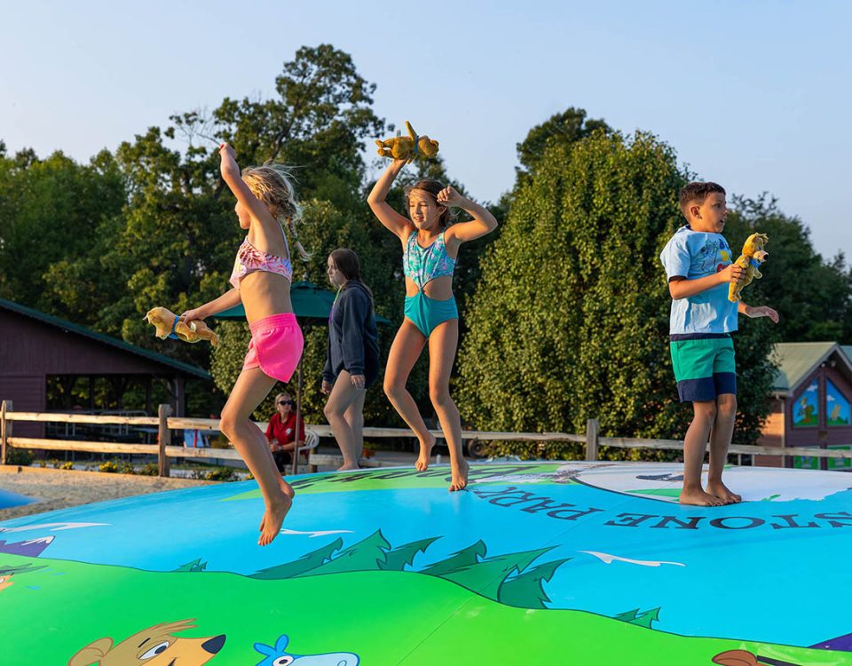 Summer camping fun at Yogi Bear's Jellystone Park in Mill Run PA includes making new friends on our jumping pillow