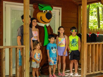 Yogi Bear™ Character Meet & Greet at Jellystone Park™ Mill Run Children meeting Yogi Bear™ outside the Bear's Den at Jellystone Park™ Mill Run in Pennsylvania.