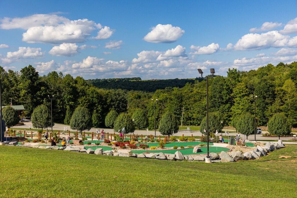 Mini Golf Course at Jellystone Park™ Mill Run Scenic view of the Mini Golf course at Jellystone Park™ Mill Run in Pennsylvania, surrounded by landscaped gardens and rolling hills.